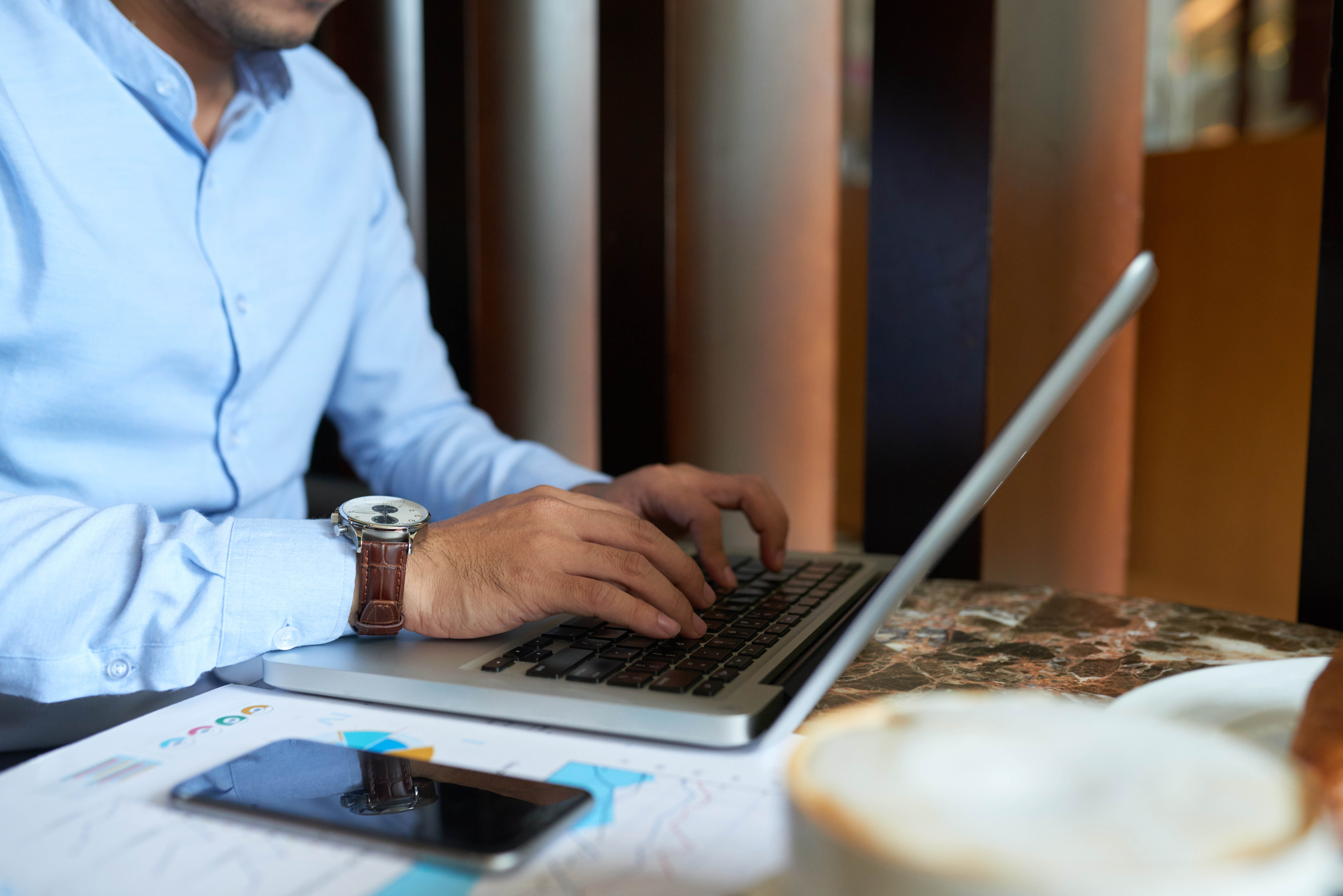 Close-up image of business executive working on laptop